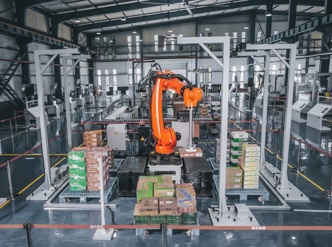 a factory with a robot in the middle of it